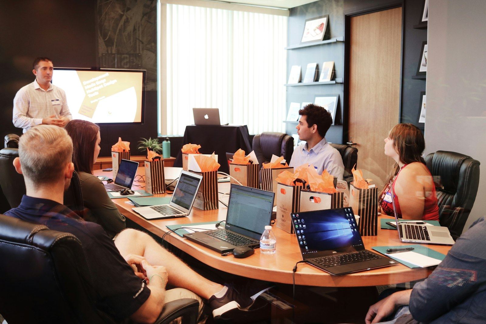 A team seated around a boardroom table during a business meeting
